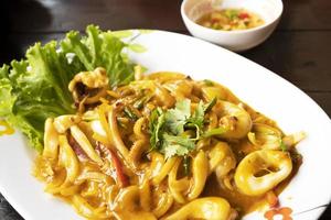 Squid stir-fried with egg yolk, Thai style photo