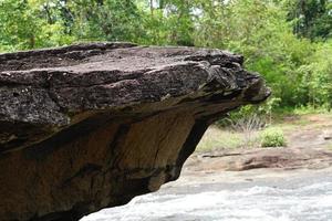 large rock that was eroded by water and wind to form a beautiful pattern. photo