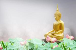 Makha Asanaha Visakha Bucha Day Golden Buddha image. Background of Bodhi leaves with shining light. Soft image and smooth focus style photo