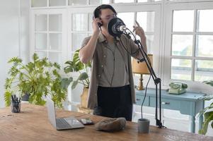 A musician man  is recording new song in home Studio photo