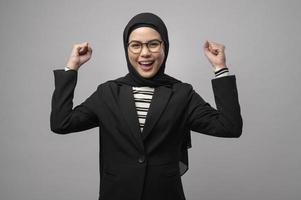 Beautiful muslim woman wearing glasses over white background studio photo