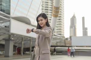 Businesswoman is using Smart watch in Modern city , business technology , city lifestyle concept photo