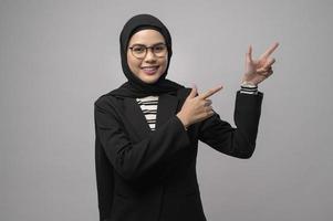 Beautiful muslim woman wearing glasses over white background studio photo