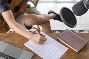 A musician is writing song in home Studio photo