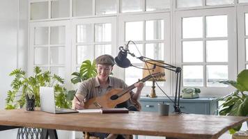 A musician is writing song in home Studio photo