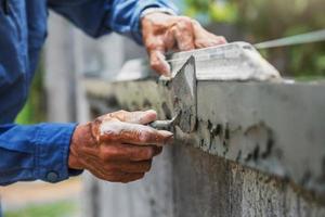 closeup hand of worker are plastering photo