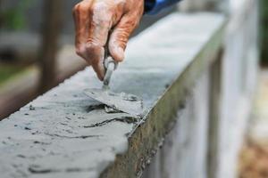 closeup hand of worker are plastering photo