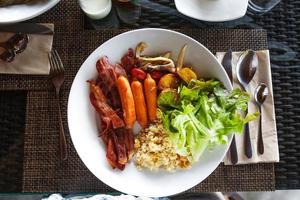 Breakfast on a plate at the hotel photo