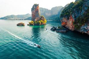 Sea views and rocky islands with a long-tail boat. photo