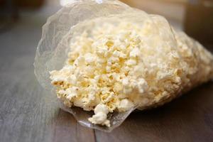 Delicious sweet Popcorn in plastic bags. photo