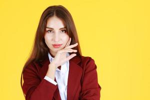 Beauty make up and good skin face of smart businesswoman in red suit isolate on yellow background photo