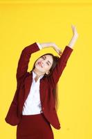 Business women is stretch lazily and closed her eyes for relaxing in lazy day after working isolated on yellow background photo