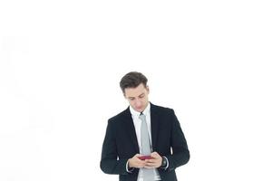 Handsome businessman in a suit hand holding smartphone isolated on white background.Copy Space photo