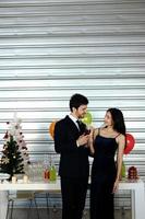 Sweet couple Love smile and spending Romantic with drinking wine in christmas time and celebrating new year eve, valentine day with colorful balloon and Gift Boxes at pantry area photo