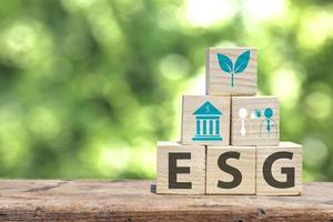 Social and environmental responsibility for sustainable development,ESG concept, good governance Environment for social sustainability,wooden box image with esg icon on wooden floor and blurry leaf photo