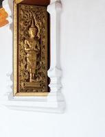 Golden angel pattern on the wood carved window. photo