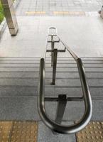 The stainless steel handrail on the staircase near the entrance of the urban railway station. photo