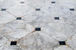 Marble tile floor with the black block. photo