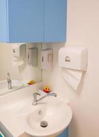 The clean hand washes basin near the corner of the medical examination room. photo