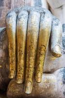 Large hand of the old Buddha statue photo