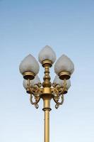 Electrical lamp with the traditional Thai pattern on the golden pole.