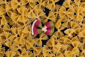 Mixed colorful farfalle pasta. Flat lay. Top view. photo
