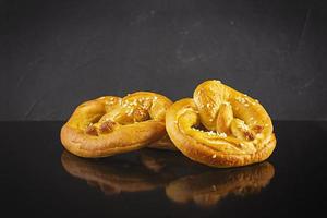 Homemade baked salt pretzel on dark background. Oktoberfest concept photo