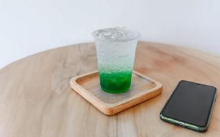 green apple soda drink on the table photo