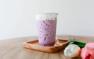 Iced taro tea with milk in a plastic cup photo