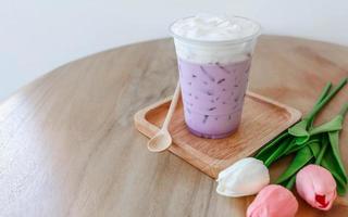 Iced taro tea with milk in a plastic cup photo