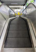 The empty modern escalator that is not yet in operation inside the suburban train station. photo