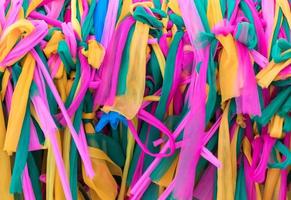 Colorful Thai style fabric which tied around the large tree. photo