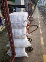 The white parcel bags in the trolley are ready for shipping to the freight train. photo