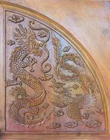 Dragon and peacock carving. photo