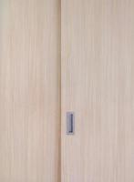 Wooden cabinet slide door with the metal handle in the minimal style. photo