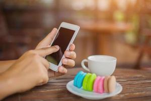 valentine macaroons with coffee on wooden table. Toned image photo
