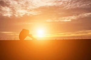 Sad and depressed woman sitting alone photo