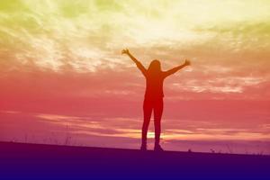 Young woman raise hands up for her success, Concept of Success in life. photo