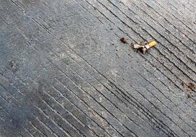 The cigarette butt let down on the concrete floor photo