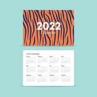 Pocket Calendar 2022 with tiger stripes on orange background. Happy new year. vector