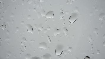 Time lapse of rain drops running down a window in a close up view. video