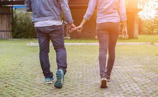 A young couple holding hands. In Nature sunrise photo