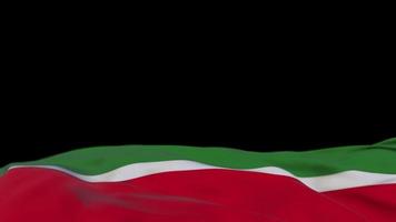 Tatarstan fabric flag waving on the wind loop. Tatarstan embroidery stiched cloth banner swaying on the breeze. Half-filled black background. Place for text. 20 seconds loop. 4k video