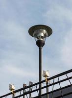 Modern lantern pole with the small lamp. photo