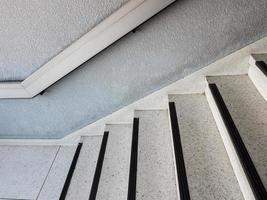 Marble pattern staircase with the metal handrail. photo