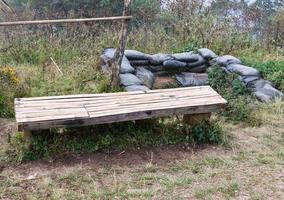 Old bamboo bench in front of the old bunker. photo