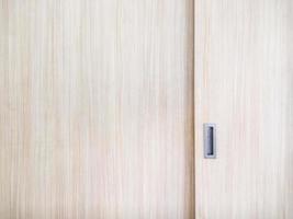 Wooden cabinet slide door with the metal handle. photo