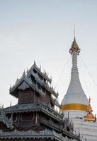 White pagoda and the old church with the metal stencil in the traditional Myanmar style. photo