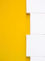 Yellow painted wall with the white brick border. photo