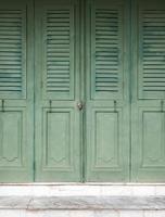 Wooden folding doors with the small lock. photo